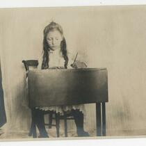 Portrait of Helen Millikin (Nash) as a girl, sitting at desk